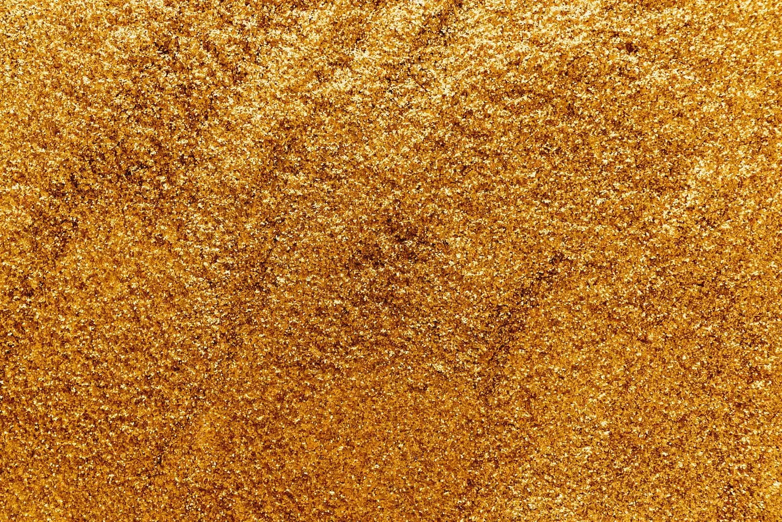 A vibrant close-up of shimmering gold glitter, perfect for festive designs.