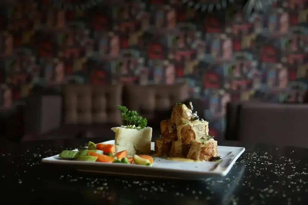 A delectable gourmet dish featuring roasted meat and colorful vegetables beautifully presented.